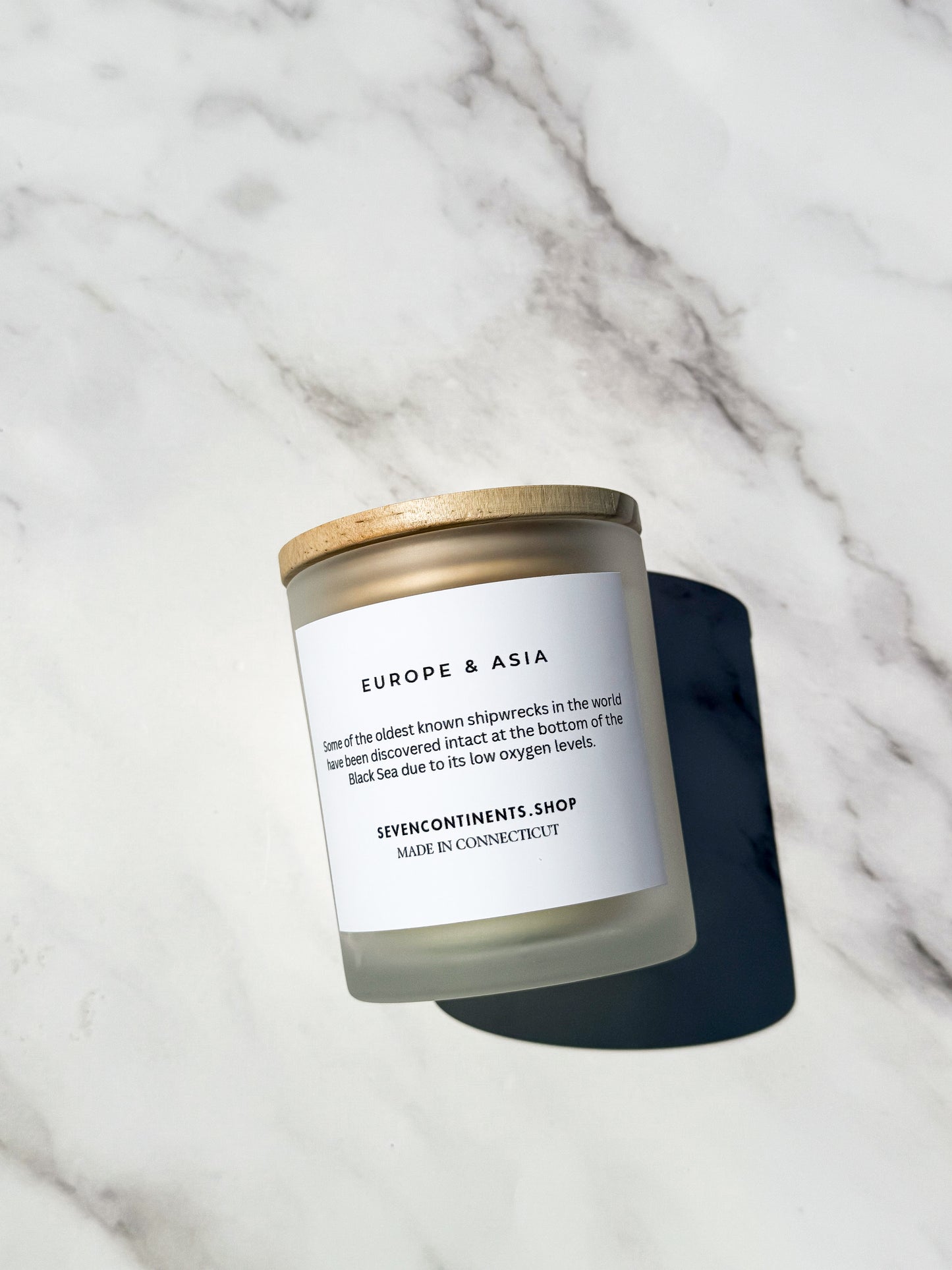 The Black Sea candle styled with moody coastal decor and dark tones
