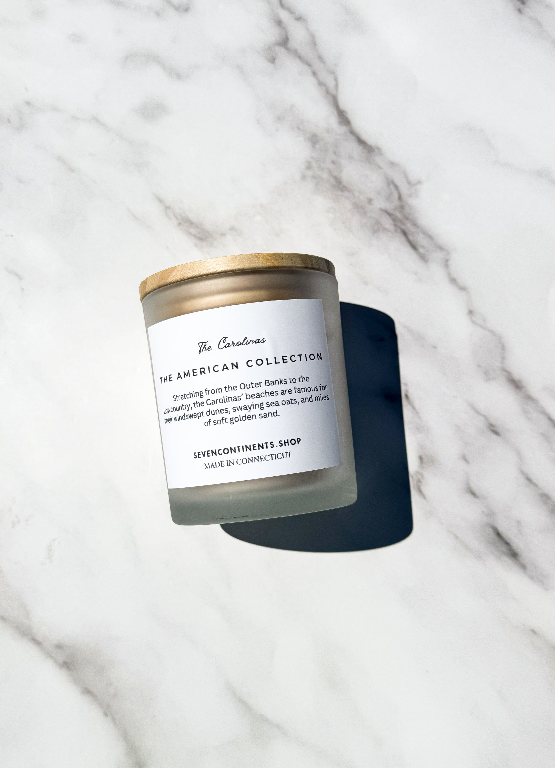 Close-up of Carolina Sea Grass candle label with sea grass, geranium, and jasmine scent notes