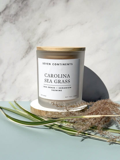 Close-up of Carolina Sea Grass candle label with sea grass, geranium, and jasmine scent notes