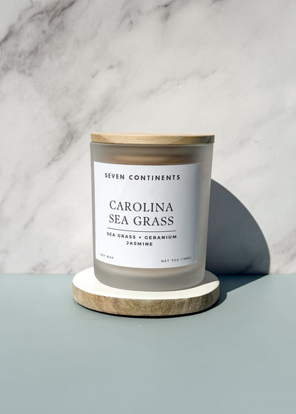 Close-up of Carolina Sea Grass candle label with sea grass, geranium, and jasmine scent notes