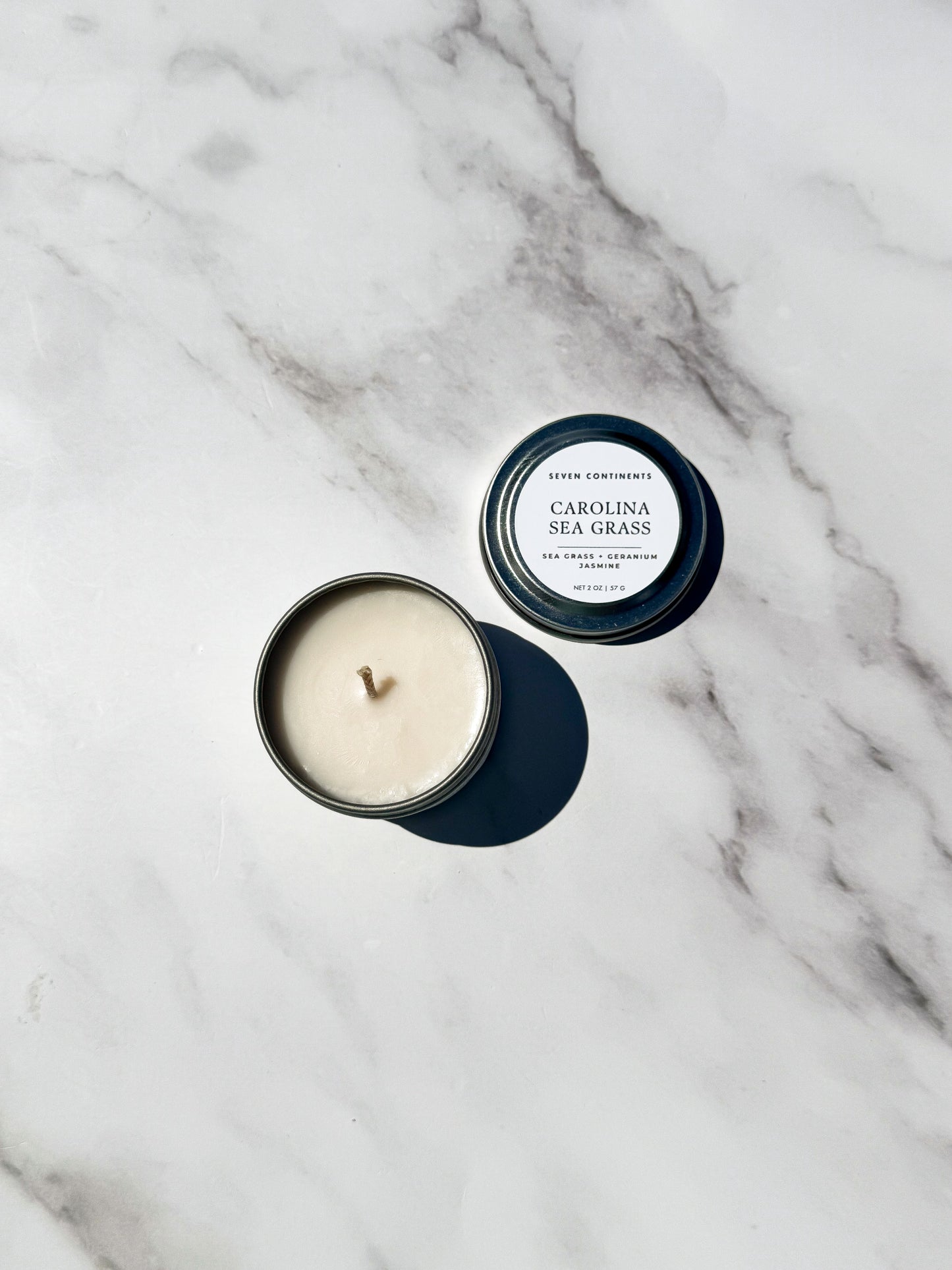 Mini Carolina Sea Grass travel 
candle with fresh sea grass and floral fragrance