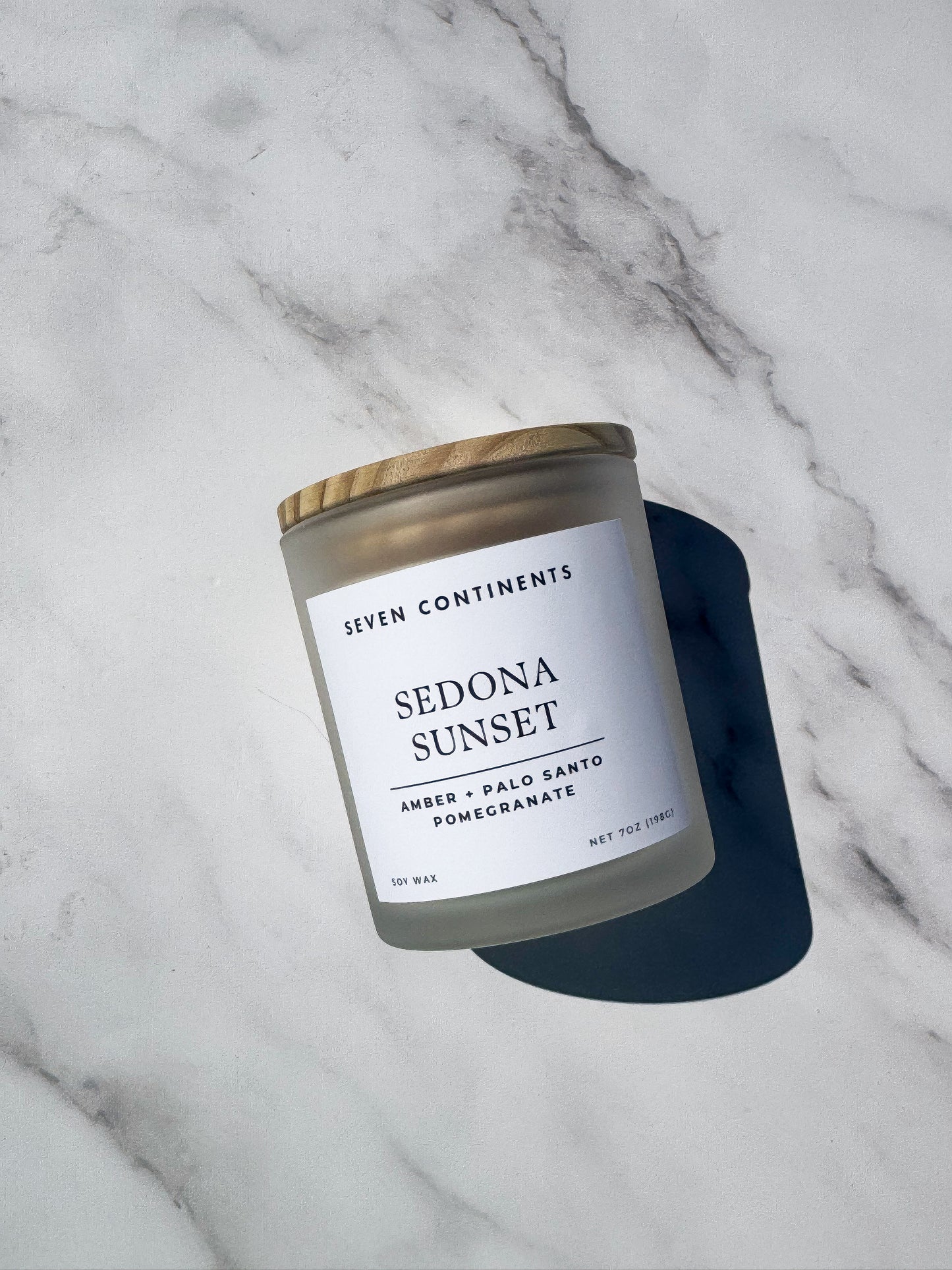 Close-up of Sedona Sunset candle label with amber, palo santo, and pomegranate scent notes