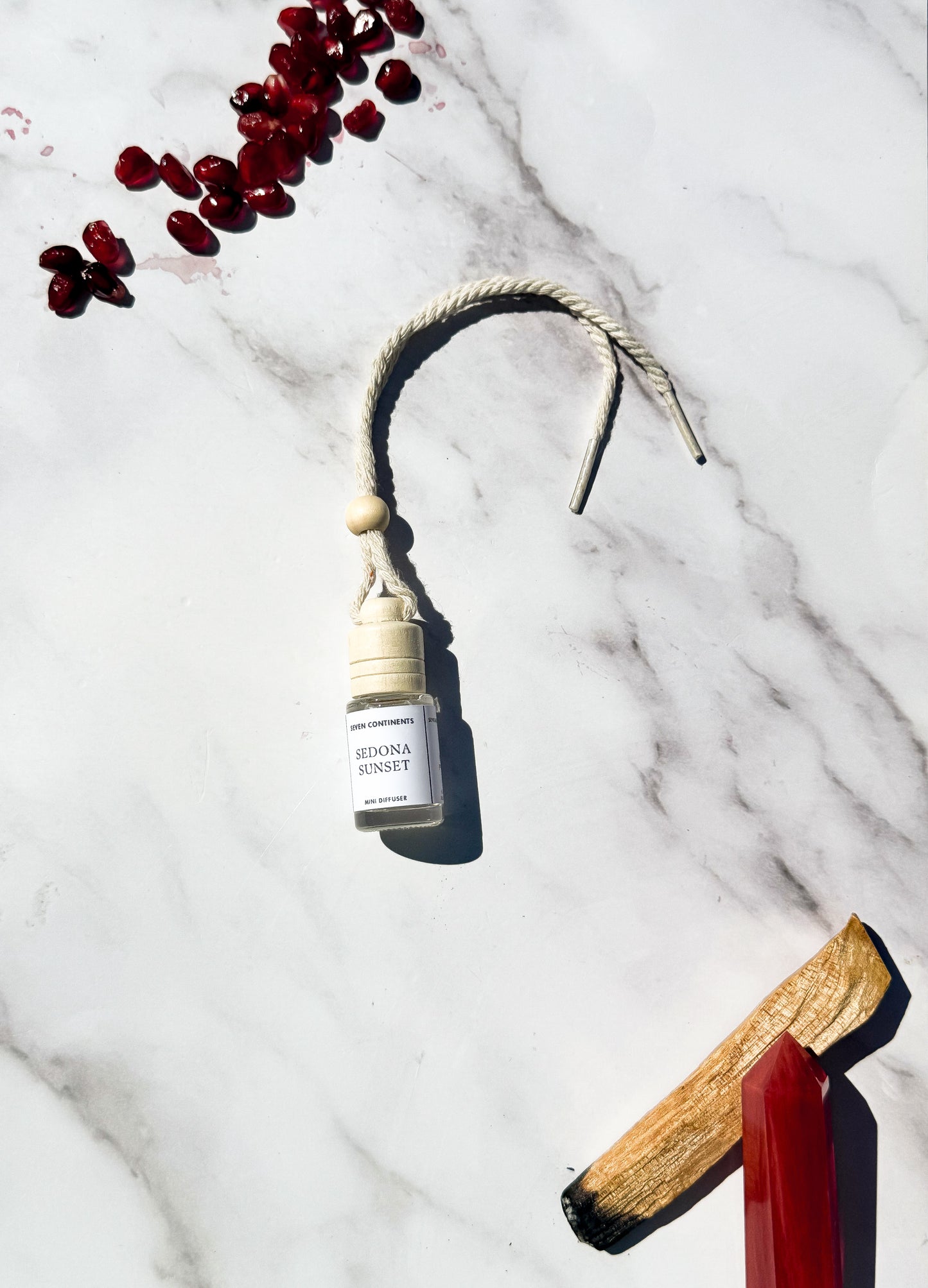 Sedona Sunset car diffuser with amber, palo santo, and pomegranate fragrance
