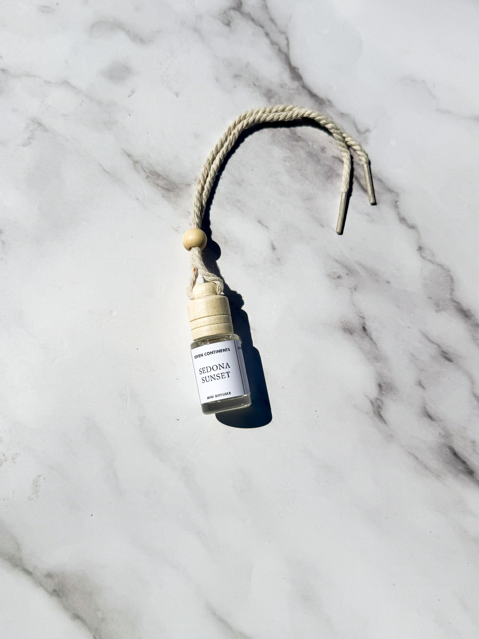 Sedona Sunset car diffuser with amber, palo santo, and pomegranate fragrance