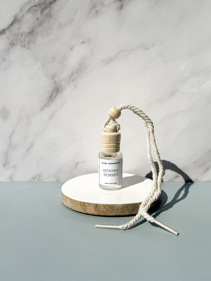 Sedona Sunset car diffuser with amber, palo santo, and pomegranate fragrance